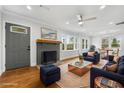 Spacious living room with modern furniture, a brick fireplace, and ample natural light at 10 Claire Se Dr, Atlanta, GA 30315