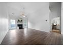Bright, airy living room featuring a fireplace, high ceilings and beautiful wood-look floors at 3047 Standing Rock Ct, Lithia Springs, GA 30122