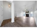 Bright, airy living room featuring a fireplace, high ceilings and beautiful wood-look floors at 3047 Standing Rock Ct, Lithia Springs, GA 30122