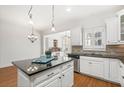 Modern kitchen with white cabinets, granite countertops, stainless steel appliances, and hardwood flooring at 4305 Kendall Way, Roswell, GA 30075