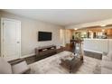 Inviting living room featuring hardwood floors, tv, and a view into the kitchen at 449 Clairemont Ave # E1, Decatur, GA 30030