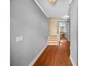 Entryway of a home featuring hardwood floors and neutral paint, leading to carpeted stairs at 1094 N Village Dr, Decatur, GA 30032