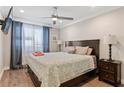 Bedroom featuring a wooden bed frame, wood flooring, a ceiling fan, and curtains at 215 Piedmont Ave # Apt 2104, Atlanta, GA 30308