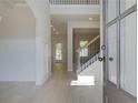 Bright and airy foyer features beautiful flooring, wainscoting, and a staircase with wrought iron spindles at 226 Linford Dr, Locust Grove, GA 30248