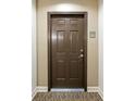 Solid brown entry door to a unit at 50 Biscayne Nw Dr # 2111, Atlanta, GA 30309