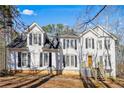 Inviting two-story home with white siding, black shutters, and a well-maintained lawn at 582 Black Forest Run, Douglasville, GA 30134