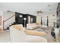 Stylish living room boasts neutral carpet, built-in cabinets, and staircase access at 582 Black Forest Run, Douglasville, GA 30134