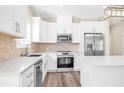 Bright kitchen featuring white cabinetry, stainless steel appliances, and center island at 653 Armitage Way, Stockbridge, GA 30281