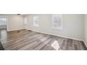 Spacious living room with lots of natural light highlighting the new floors at 1694 Kenmore Sw St, Atlanta, GA 30311