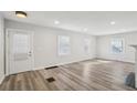 Bright living room with new floors, neutral paint, and a modern ceiling fan at 1694 Kenmore Sw St, Atlanta, GA 30311