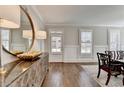 Open dining room featuring hardwood flooring, modern decor, and natural light through shuttered windows at 3601 Ridgeway Rd, Duluth, GA 30096