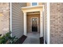 Close up of the front door of the townhome, with white pillars and brick surround at 813 Whittington Sw Pkwy, Marietta, GA 30060