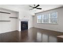 Spacious living room with dark hardwood floors, fireplace, and shelves at 813 Whittington Sw Pkwy, Marietta, GA 30060