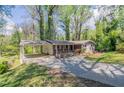 Cozy single story home featuring covered parking, a brick facade, and a well-maintained yard at 1753 Dodson Sw Dr, Atlanta, GA 30311