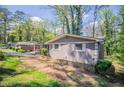 Side view of a well-maintained home with brick and siding, complemented by mature landscaping at 1753 Dodson Sw Dr, Atlanta, GA 30311