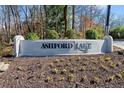 Ashford Lake community sign surrounded by well-maintained landscaping and greenery at 3928 Ashford Lake Ne Ct, Brookhaven, GA 30319