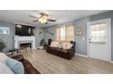 Cozy living room with a fireplace, modern ceiling fan, and neutral paint at 2860 River Close Dr, Decatur, GA 30034