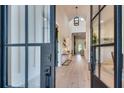 Bright foyer with high ceilings, hardwood floors, and black-framed glass doors and large windows for natural light at 2497 Sugar Pike Rd, Canton, GA 30115