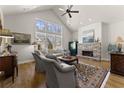 Bright living room with a vaulted ceiling, large windows, stone fireplace, and hardwood floors at 336 Little Pine Ln, Woodstock, GA 30188