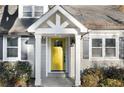 Close up of a home's inviting entrance with a bright yellow door and stylish architectural features at 3451 Keswick Ct, Atlanta, GA 30341