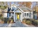 Inviting home exterior with a yellow front door, lush landscaping, and classic architectural details at 3451 Keswick Ct, Atlanta, GA 30341