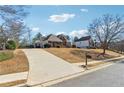 Spacious home with a long driveway and well-kept lawn, showcasing suburban living at its finest at 3999 Treemont Ln, Suwanee, GA 30024