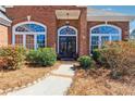 Charming front entrance featuring a stylish door and manicured bushes leading to a warm welcome at 3999 Treemont Ln, Suwanee, GA 30024