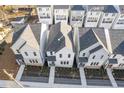 Aerial view of townhomes featuring dark roofs, light exteriors and coordinated landscaping at 489 Hammons Way, Atlanta, GA 30315