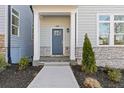 Inviting entrance with a blue door, stone accents, and manicured landscaping at 489 Hammons Way, Atlanta, GA 30315