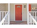 Close-up of a red front door with white trim and a welcoming entrance at 5537 Riverside Dr, Sugar Hill, GA 30518