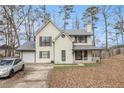 Beautiful two-story home featuring white siding, brick details, and well-maintained landscaping at 9556 River Ct, Jonesboro, GA 30238