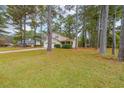 Well-manicured front yard with mature trees enhancing the curb appeal of this traditional-style two-story home at 5065 Hubert Dr, Powder Springs, GA 30127