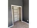 Bedroom closet with shelves and hanging bar, providing ample storage space at 5891 Raven Ln, Lithonia, GA 30058