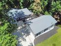 A bird's eye view of a single-story home surrounded by beautiful trees and featuring a spacious driveway at 7360 Fields Dr, Cumming, GA 30041