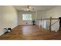 Spacious living room with hardwood floors, lots of light, and a ceiling fan at 893 Boca Raton Dr, Forest Park, GA 30297