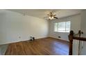 Bright living room featuring beautiful hardwood floors and a large window offering ample natural light at 893 Boca Raton Dr, Forest Park, GA 30297