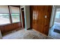 Bedroom featuring wood paneled wall and several windows for natural light at 2914 Wanda Sw Cir, Atlanta, GA 30315