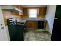 Kitchen with wooden cabinets, laminate countertops, and black appliances at 2914 Wanda Sw Cir, Atlanta, GA 30315