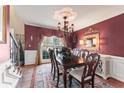 Elegant dining room with hardwood floors, chandelier, and large windows offering natural light at 154 Hunters Trl, Dallas, GA 30157