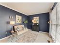 Stylish living room with blue walls, neutral carpet, a comfortable couch, and decorative art at 154 Hunters Trl, Dallas, GA 30157