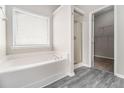 Bright bathroom boasting a soaking tub, separate shower, and modern fixtures at 503 Goldfinch Way, Stockbridge, GA 30281