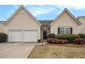 Charming home featuring a two-car garage, manicured lawn, and inviting entrance at 503 Goldfinch Way, Stockbridge, GA 30281