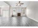 Spacious living room featuring a fireplace, neutral walls, a ceiling fan, and sliding door access to the outside at 503 Goldfinch Way, Stockbridge, GA 30281