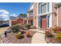 Well-manicured front yard featuring a brick walkway leading to a covered front porch at 6068 Magnolia Rdg, Stone Mountain, GA 30087