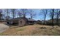 View of the home featuring a ramp, garage, and a spacious grassy yard at 2539 Britt Rd, Snellville, GA 30078