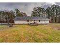 Back exterior view of white home with wood deck and fenced yard at 2375 Gum Creek Rd, Oxford, GA 30054