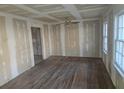 Bright living room featuring unfinished drywall, hardwood floors, and natural light from the windows at 2909 Diana Sw Dr, Atlanta, GA 30315