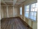 Inviting living room featuring unfinished drywall, hardwood floors, and natural light from the windows at 2909 Diana Sw Dr, Atlanta, GA 30315