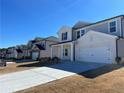 Exterior view of a neighborhood street showcasing several newly constructed two-story homes at 4161 Dean Grove Way, Loganville, GA 30052