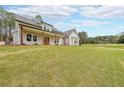 Inviting house featuring a covered entryway, large windows, and a sprawling green lawn at 46 Lexie Ct, Rockmart, GA 30153